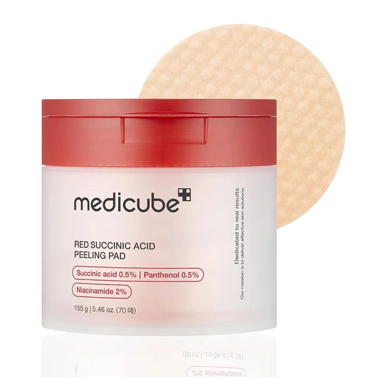 Medicube Red Succinic Acid Peeling Pad jar with a bold red cap and textured exfoliating pad displayed behind it.